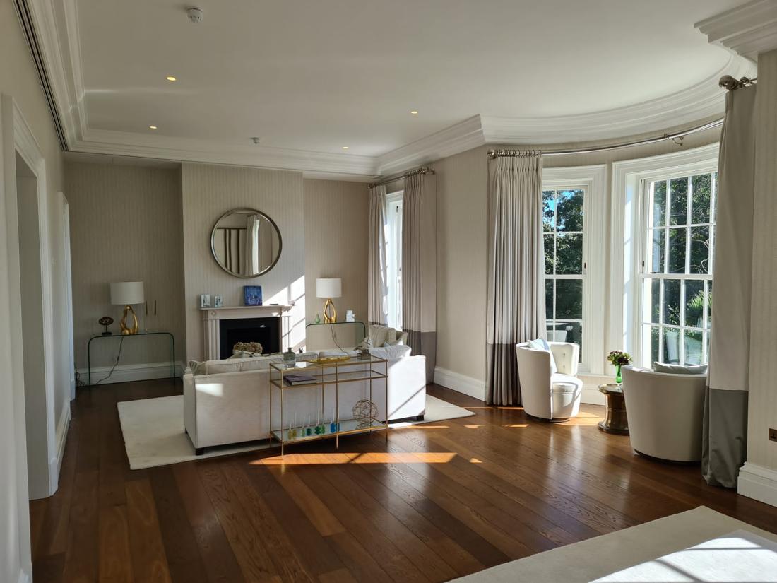 Drawing room with soft grey walls and white cornicing