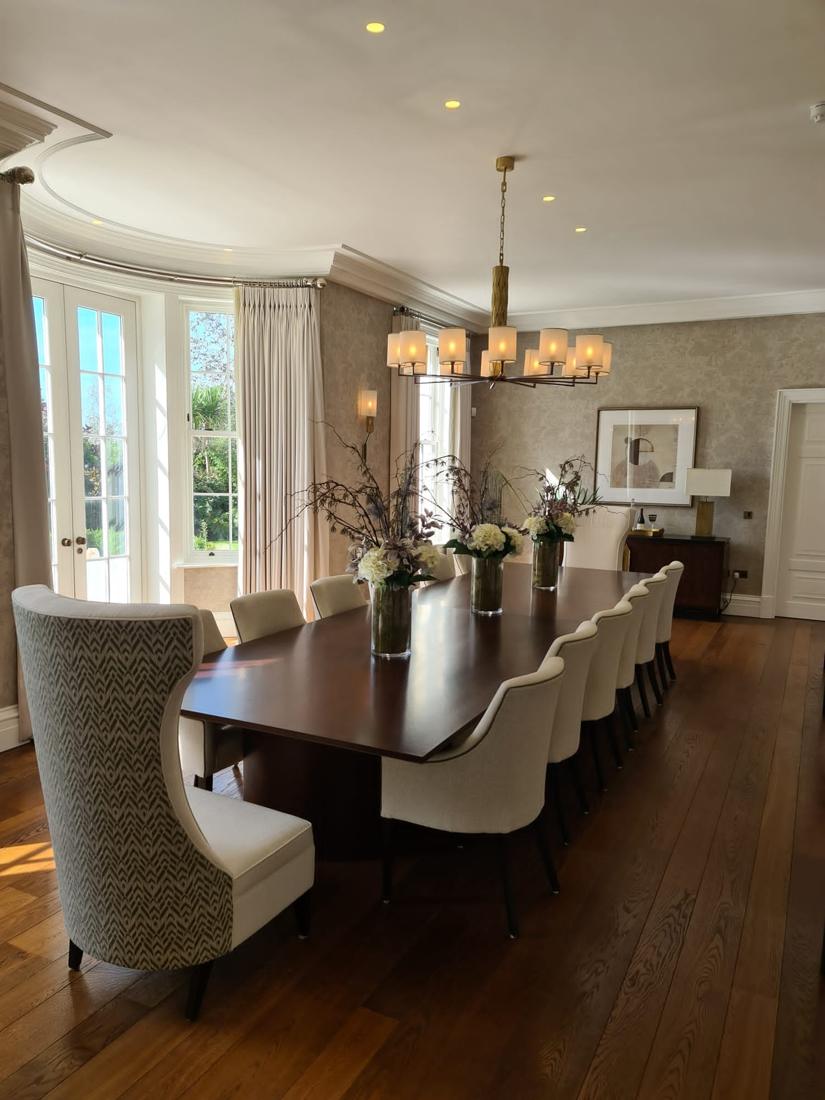 Dining room with long table and bay windows