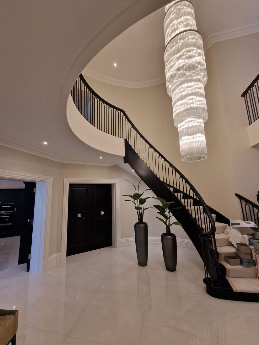 Curved staircase with black balustrade
