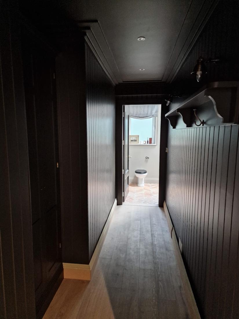 Panelled corridor in deep espresso brown