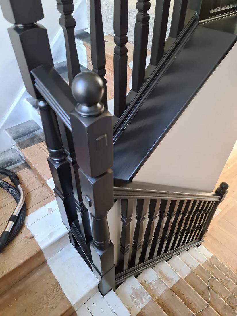 Staircase newel and spindles painted dark grey