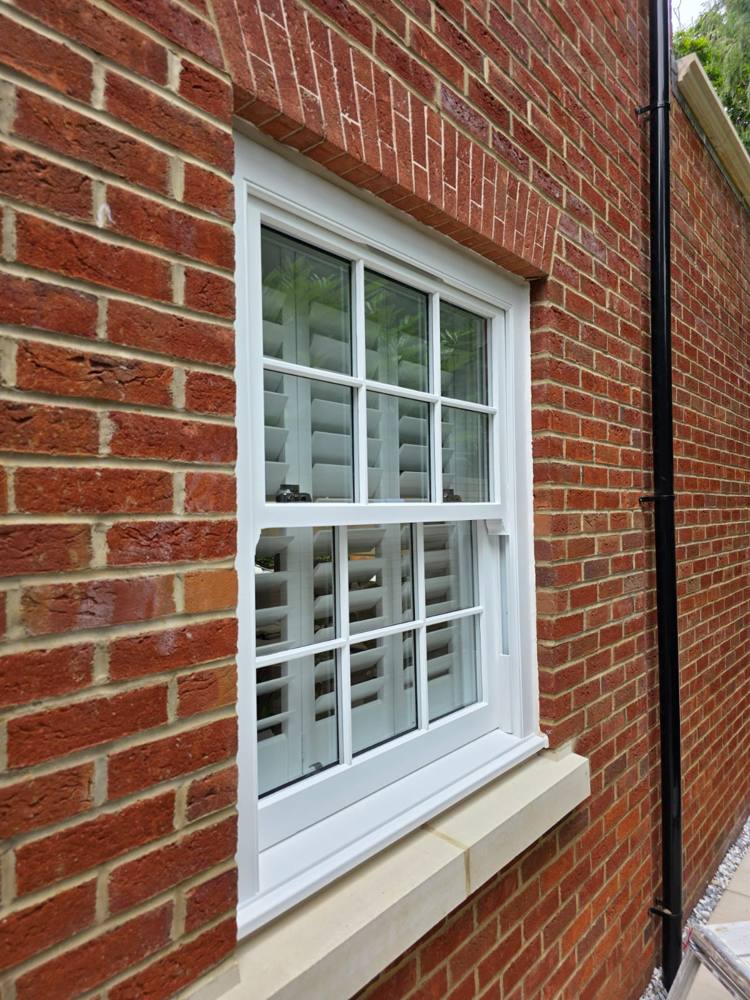 Freshly painted sash window in red brick